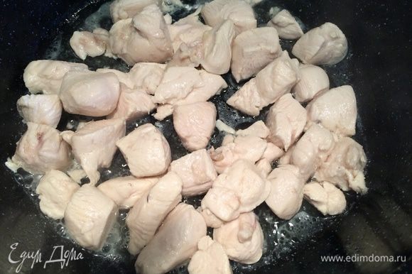 В сковороду налить подсолнечное масло, положить кусочки курицы, готовить на среднем огне, периодически помешивая.